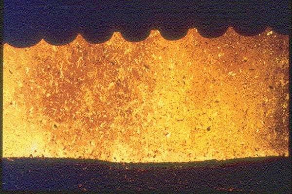 FIGURE 1.  This wood-fired boiler furnace with a pneumatic spreader stoker shows lots of wood particles and burning embers above the grates Tom McGowan